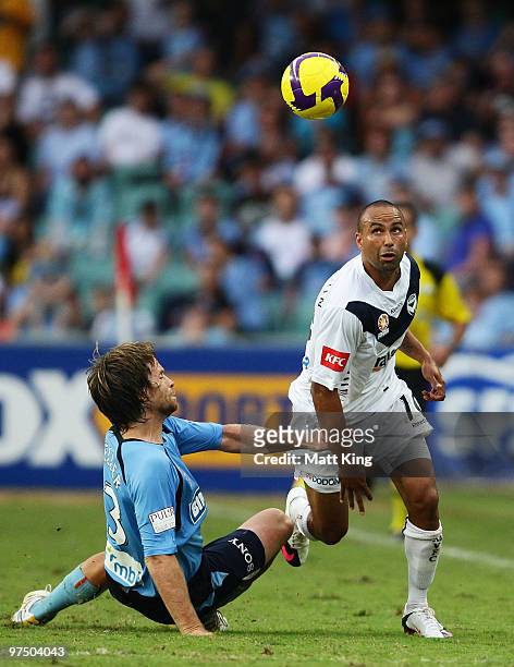 Archie Thompson of the Victory controls the ball in front of Stephan Keller of Sydney during the A-League Major Semi Final match between Sydney FC...