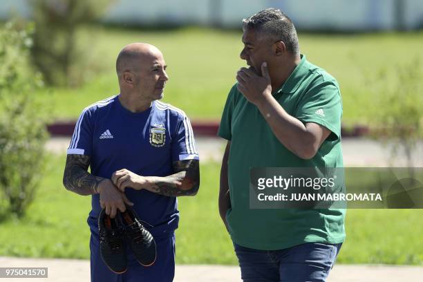 Argentina's football federation president Claudio Tapia talks to coach Jorge Sampaoli as they arrive for a training session at the team's base camp...
