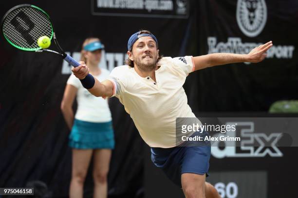 Lucas Pouille of France plays a forehand to Denis Istomin of Uzbekistan during day 5 of the Mercedes Cup at Tennisclub Weissenhof on June 15, 2018 in...