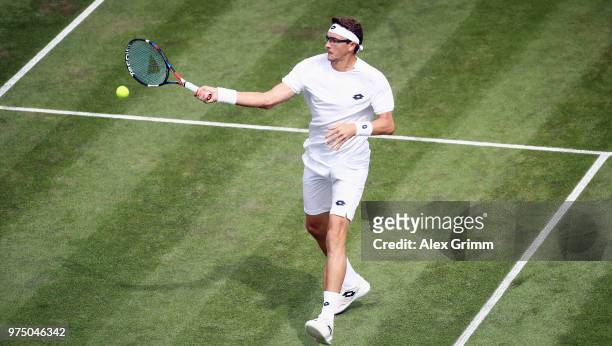 Denis Istomin of Uzbekistan plays a forehand to Lucas Pouille of France during day 5 of the Mercedes Cup at Tennisclub Weissenhof on June 15, 2018 in...