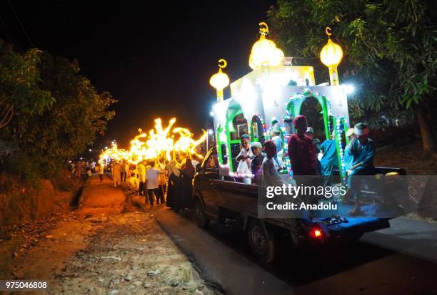 Number of young people carry lanterns bearing Asmaul Husna or the name of Allah, in the evening parade of takbeer welcoming Eid al-Fitr in the next...