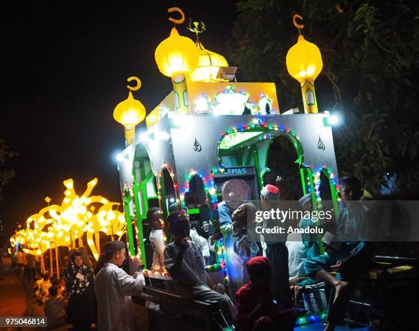 Number of young people carry lanterns bearing Asmaul Husna or the name of Allah, in the evening parade of takbeer welcoming Eid al-Fitr in the next...