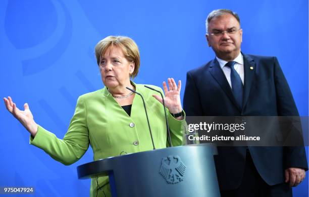 May 2018, Germany, Berlin: Member of the Presidency of Bosnia and Herzegovina Mladen Ivanic taking part in a press conference with federal chancellor...