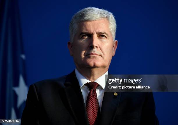 May 2018, Germany, Berlin: Member of the Presidency of Bosnia and Herzegovina Dragan Covic taking part in a press conference with federal chancellor...