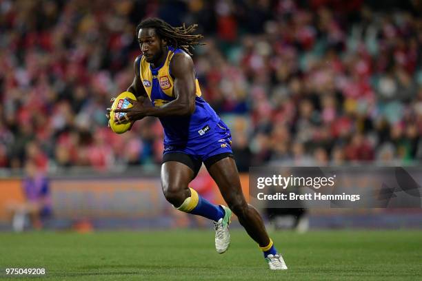 Nic Naitanui of the Eagles runs with the ball during the round 13 AFL match between the Sydney Swans and the West Coast Eagles at Sydney Cricket...