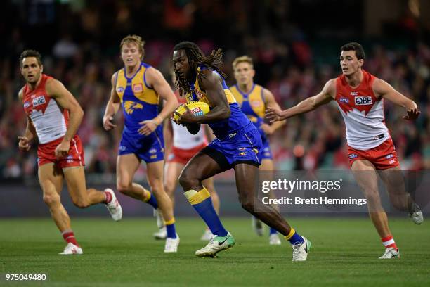 Nic Naitanui of the Eagles runs with the ball during the round 13 AFL match between the Sydney Swans and the West Coast Eagles at Sydney Cricket...