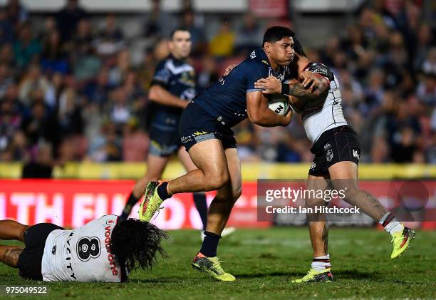 Jason Taumalolo of the Cowboys is tackled by Issac Luke and James Gavet of the Warriors during the round 15 NRL match between the North Queensland...