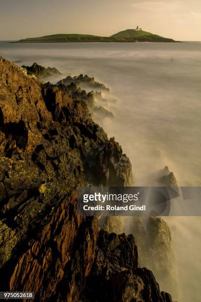 rocky coastline and hill in background, ballycotton, county cork, ireland, uk - republic of ireland stock pictures, royalty-free photos & images