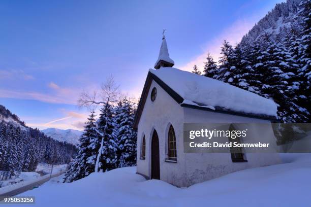 maria-hilf-kapelle in snow and mountains in the background, tirol, austria - kapelle stock pictures, royalty-free photos & images