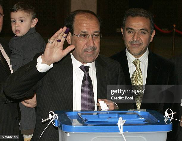 Iraqi's Prime Minister Nuri al-Maliki casts his vote at a ballot box for the Iraqi parlaimentary elections, in a polling station in the green zone on...