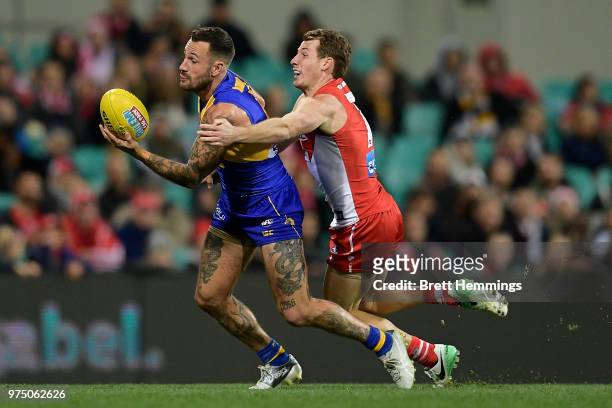 Harry Cunningham of the Swans tackles Chris Masten of the Eagles during the round 13 AFL match between the Sydney Swans and the West Coast Eagles at...