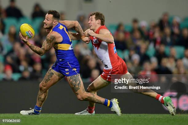 Harry Cunningham of the Swans tackles Chris Masten of the Eagles during the round 13 AFL match between the Sydney Swans and the West Coast Eagles at...