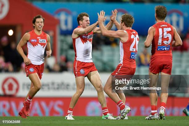 Harry Cunningham of the Swans celebrates kicking a goal with team mates during the round 13 AFL match between the Sydney Swans and the West Coast...
