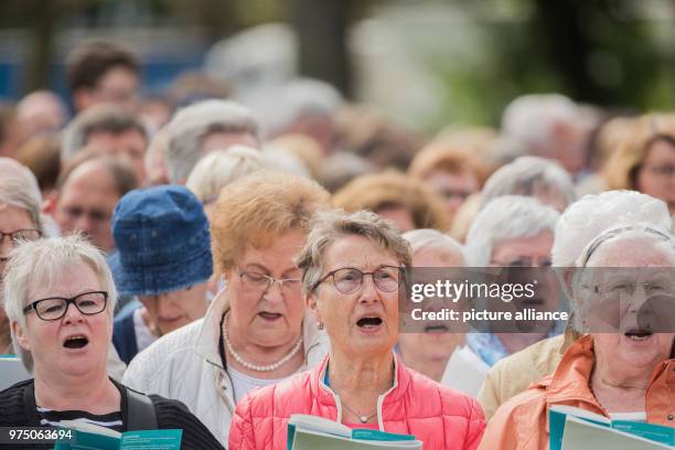 May 2018, Germany, Muenster: Believers singing at a service for Ascension Day. From the 09 May until the 13 May Catholic Day is taking place in...