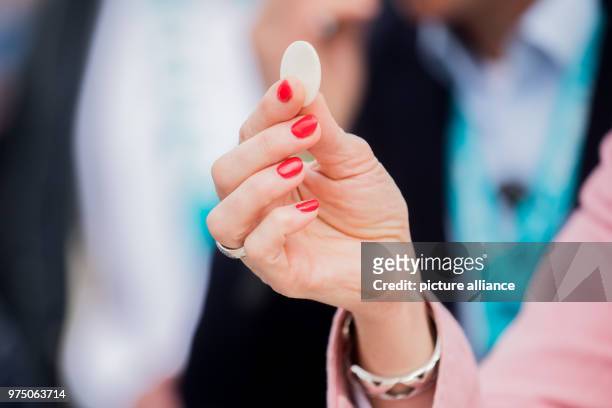 May 2018, Germany, Muenster: A woman holding altar bread at the service for Ascension Day. From the 09 May until the 13 May Catholic Day is taking...