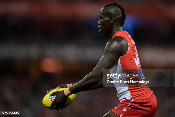 Aliir Aliir of the Swans controls the ball during the round 13 AFL match between the Sydney Swans and the West Coast Eagles at Sydney Cricket Ground...