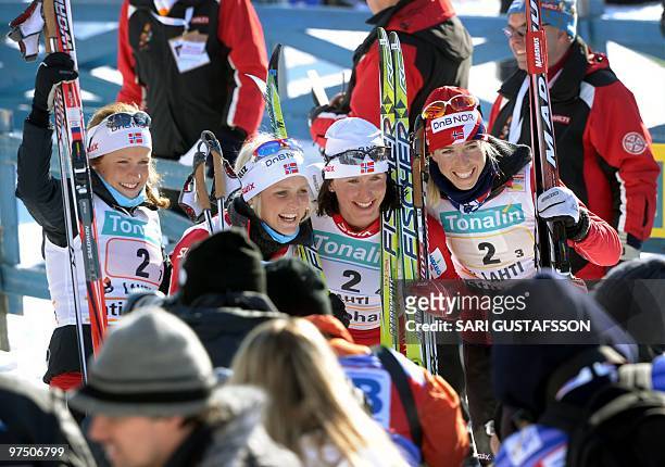 The winners of Norway Marthe Kristoffersen, Therese Johaug, Marit Björgen and Kristin Steira pose after carrying off the ladies' 4 x 5 km...