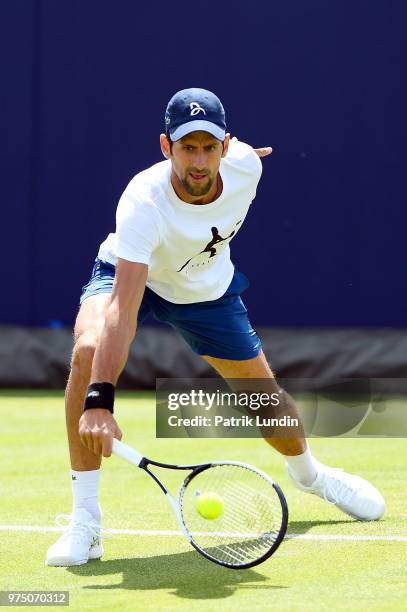 Novak Djokovic of Serbia reach hits a backhand in practice during preview Day 3 of the Fever-Tree Championships at Queens Club on June 15, 2018 in...