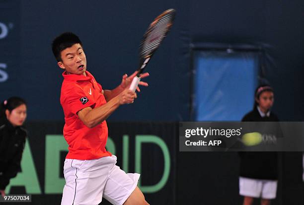 Wu Di, 18 years old and ranked a lowly 670th in the world, returns a shot against Uzbekistan's Farrukh Dustov in the final match of the Davis Cup tie...