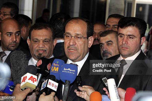Iraqi's Prime Minister Nuri al-Maliki speaks to reporters after voting at a polling station, in the green zone on March 07, 2010 in Baghdad, Iraq....