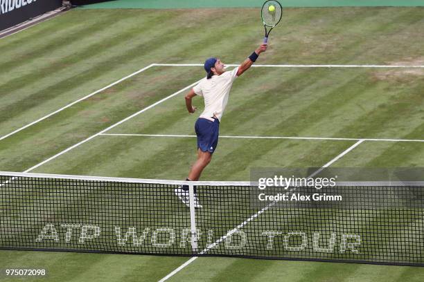 Lucas Pouille of France plays a backhand smash to Denis Istomin of Uzbekistan during day 5 of the Mercedes Cup at Tennisclub Weissenhof on June 15,...