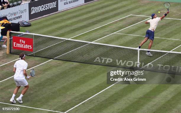 Lucas Pouille of France plays a backhand smash to Denis Istomin of Uzbekistan during day 5 of the Mercedes Cup at Tennisclub Weissenhof on June 15,...