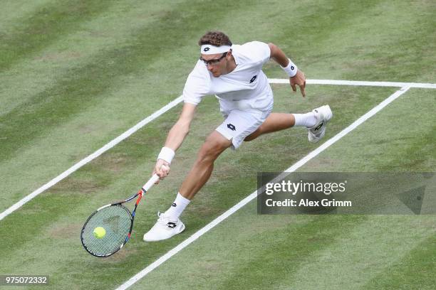 Denis Istomin of Uzbekistan plays a forehand to Lucas Pouille of France during day 5 of the Mercedes Cup at Tennisclub Weissenhof on June 15, 2018 in...