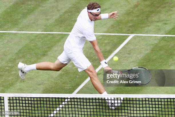 Denis Istomin of Uzbekistan plays a volley to Lucas Pouille of France during day 5 of the Mercedes Cup at Tennisclub Weissenhof on June 15, 2018 in...
