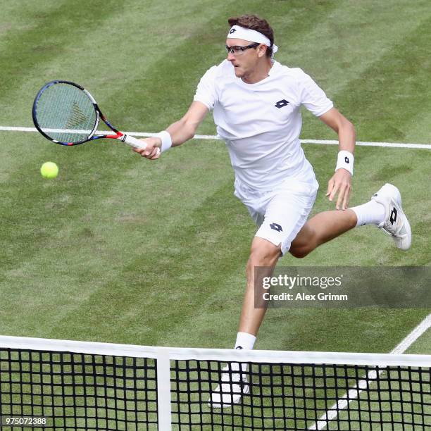 Denis Istomin of Uzbekistan plays a volley to Lucas Pouille of France during day 5 of the Mercedes Cup at Tennisclub Weissenhof on June 15, 2018 in...