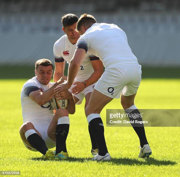 George Ford is held by Ben Youngs and Owen Farrell during the England training session at Kings Park Stadium on June 15, 2018 in Durban, South Africa.