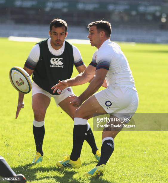 George Ford off loads the ball watched by Alex Lozowski during the England training session at Kings Park Stadium on June 15, 2018 in Durban, South...