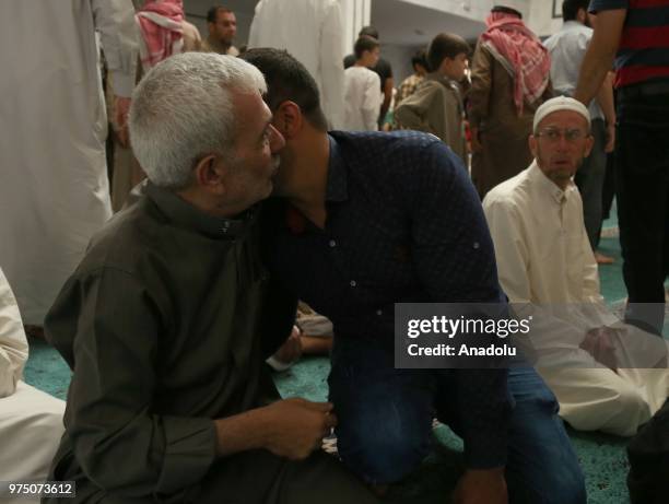 Syrian people greet each other after performed Eid al-Fitr prayer at Ez Zehra Mosque in Al-Bab district of Aleppo, Syria on June 15, 2018. Turkey's...