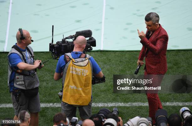 Singer Robbie Williams gestures into a TV camera during the opening ceremony prior to the 2018 FIFA World Cup Russia group A match between Russia and...