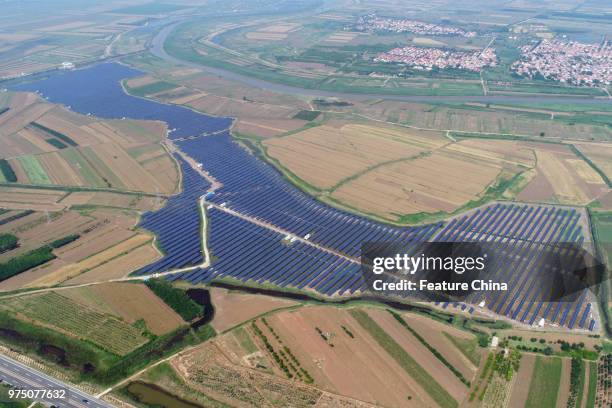 View of a solar station built in the ponds of a duck farm to maximize land usage in Binzhou in east China's Shandong province Thursday, June 14,...