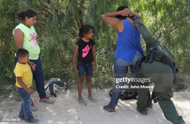 Central American asylum seekers are taken into custody by U.S. Border Patrol agents on June 12, 2018 near McAllen, Texas. The families were then sent...