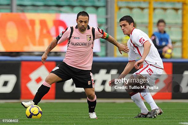 Fabrizio Miccoli of Palermo and Romano Perticone of Livorno compete for the ball during the Serie A match between US Citta di Palermo and AS Livorno...