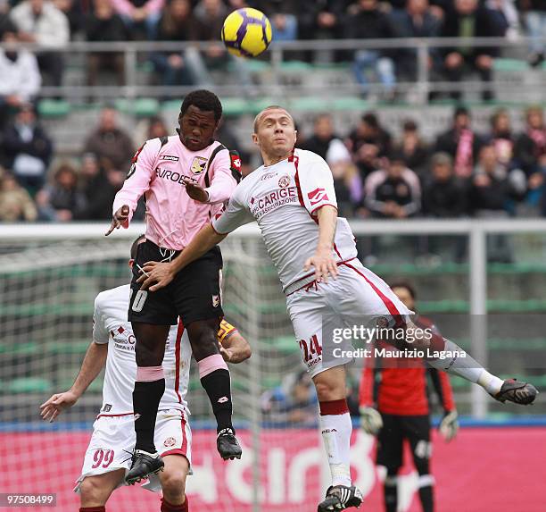 Fabio Simplicio of US Citta' di Palermo battles for the ball with Santos Batista Junior Mozart of AS Livorno Calcio during the Serie A match between...