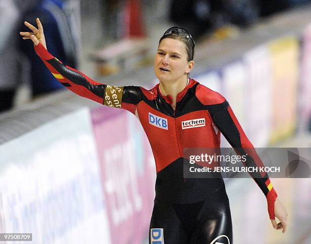 Germany's Jenny Wolf celebrates after winning in the women's 500m Speed skating race of the ISU World Cup in the eastern German city of Erfurt on...
