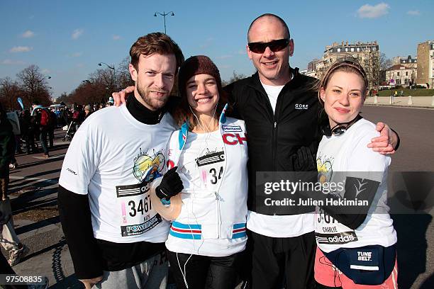 Nick Saunders, Natalia Vodianova, Dinos Chapman and Charlie Lesueur pose with fans before running Paris Semi-Marathon on the benefit of "Naked Heart...