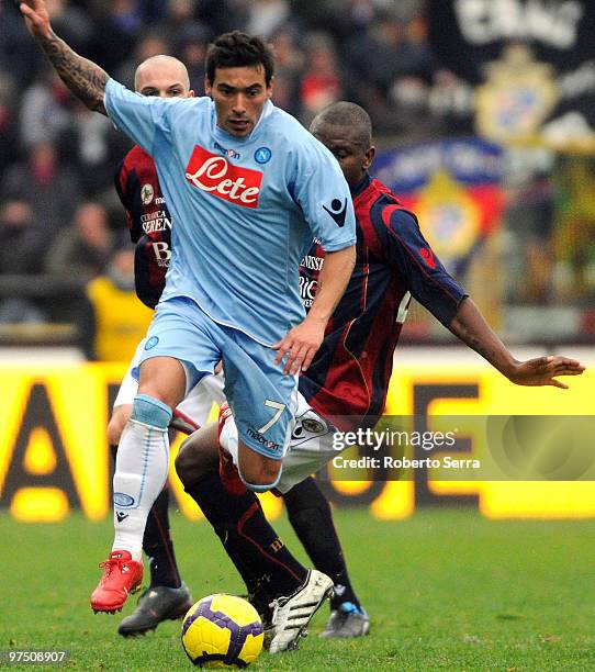 Ezequiel Ivan Lavezzi of Napoli competes with Gaby Mudingayi of Bologna during the Serie A match between Bologna FC and SSC Napoli at Stadio Renato...