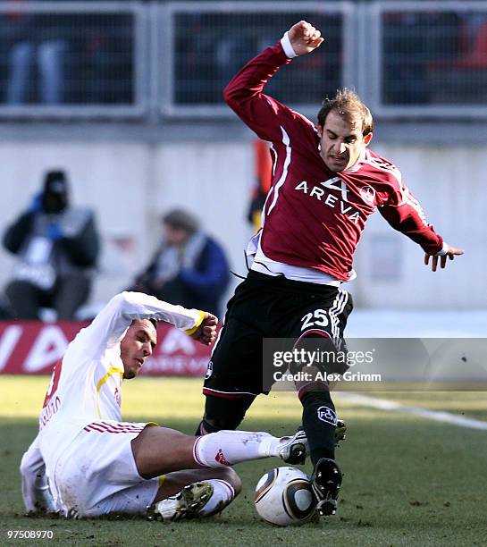 Javier Pinola of Nuernberg is challenged by Renato Augusto of Leverkusen during the Bundesliga match between 1. FC Nuernberg and Bayer Leverkusen at...