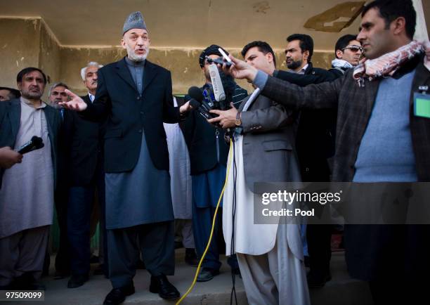 Afghan President Hamid Karzai talks to media after meeting with local elders March 7, 2010 in the southern province of Helmand of Marjah,...