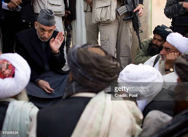 Afghan President Hamid Karzai talks to locals March 7, 2010 in the southern province of Helmand of Marjah, Afghanistan. Afghan President Hamid Karzai...