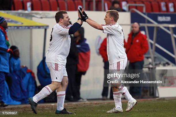 Oliver Pocher of the ran AllstarTeam celebrates with his team mate Elton during the charity match for earthquake victims in Haiti between ran Allstar...