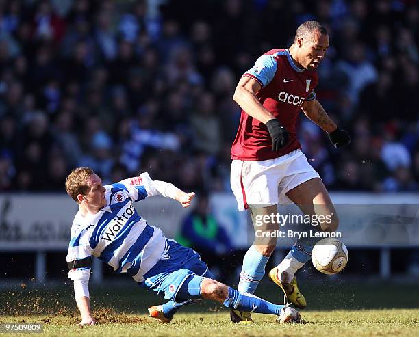 Ryan Bertrand of Reading tackles John Carew of Aston Villa during the E.ON sponsored FA Cup Quarter Final match between Reading and Aston Villa at...