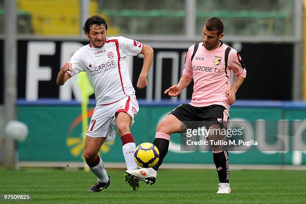 Antonio Nocerino of Palermo and Cristian Raimondi of Livorno compete for the ball during the Serie A match between US Citta di Palermo and AS Livorno...