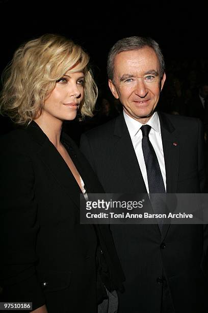 Charlize Theron and Bernard Arnault attends the Christian Dior Ready to Wear show as part of the Paris Womenswear Fashion Week Fall/Winter 2011 at...