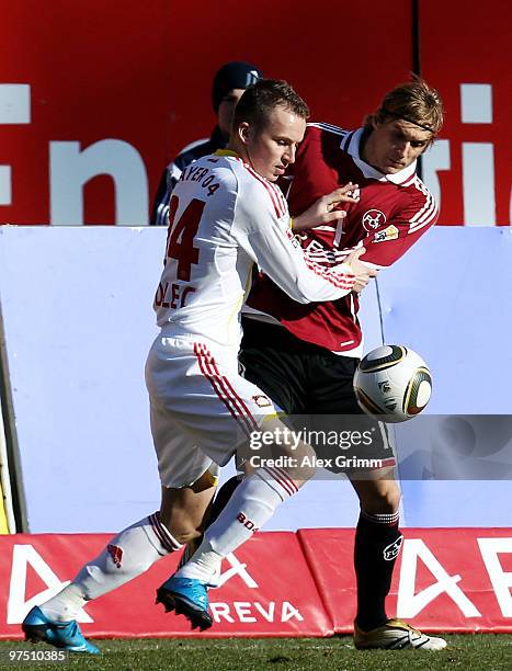 Michal Kadlec of Leverkusen is challenged by Marcel Risse of Nuernberg during the Bundesliga match between 1. FC Nuernberg and Bayer Leverkusen at...