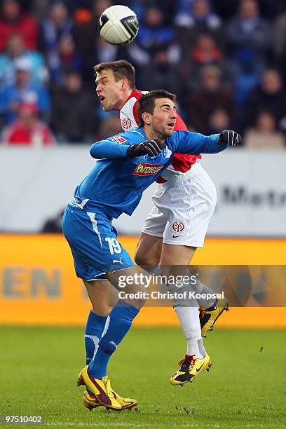 Vedad Ibisevic of Hoffenheim and Radoslav Zabavnik of Mainz go up for a header during the Bundesliga match between 1899 Hoffenheim and FSV Mainz at...