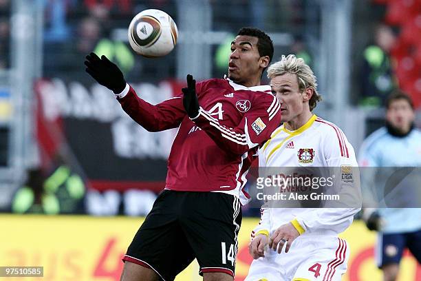 Eric Maxim Choupo-Moting of Nuernberg is challenged by Sami Hyypiae of Leverkusen during the Bundesliga match between 1. FC Nuernberg and Bayer...